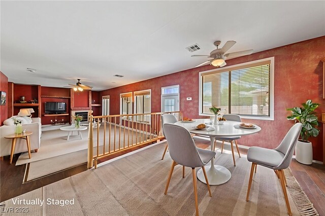 4883 Grey Mesa St, Las Vegas, NV 89149 - dining area with ceiling fan, wood finished floors, and a fireplace