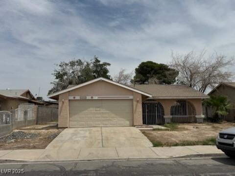 2450 Oak Glen Way, Las Vegas, NV 89115 - ranch-style house featuring an attached garage, concrete driveway, and stucco siding