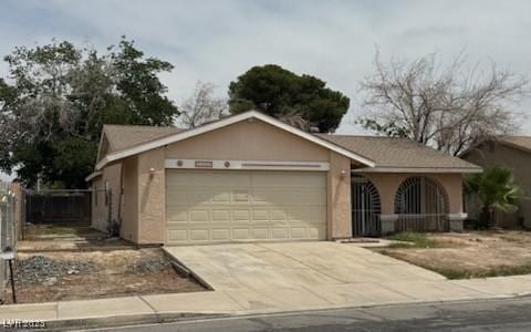 2450 Oak Glen Way, Las Vegas, NV 89115 - ranch-style house with a garage, driveway, and stucco siding