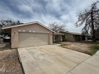 2450 Oak Glen Way, Las Vegas, NV 89115 - ranch-style home featuring an attached garage and concrete driveway