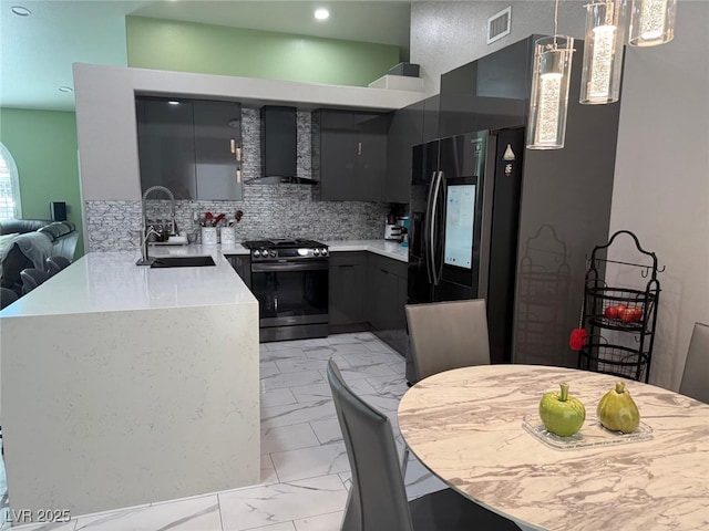 6248 Sapporo Cir, Las Vegas, NV 89110 - kitchen featuring wall chimney range hood, stainless steel range with gas stovetop, refrigerator with ice dispenser, a sink, and light countertops