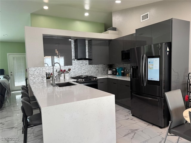 6248 Sapporo Cir, Las Vegas, NV 89110 - kitchen with refrigerator with ice dispenser, wall chimney exhaust hood, gas stove, a sink, and a peninsula