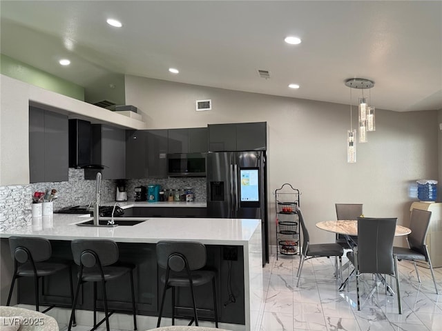 6248 Sapporo Cir, Las Vegas, NV 89110 - kitchen with stainless steel appliances, a peninsula, tasteful backsplash, light countertops, and modern cabinets