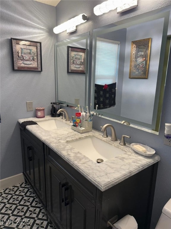 6248 Sapporo Cir, Las Vegas, NV 89110 - bathroom featuring double vanity and baseboards