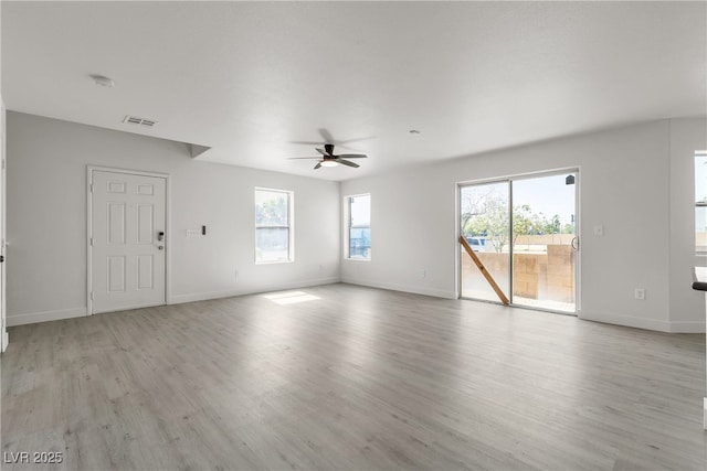 6117 Daisy Lee Ave, Las Vegas, NV 89108 - unfurnished living room featuring a ceiling fan, light wood finished floors, and baseboards