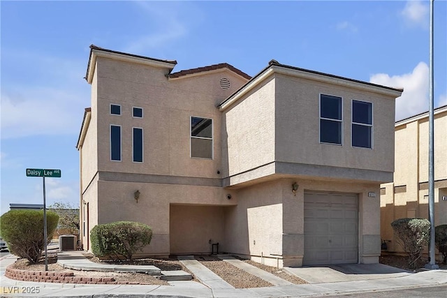 6117 Daisy Lee Ave, Las Vegas, NV 89108 - view of front facade featuring a garage, stucco siding, and central AC