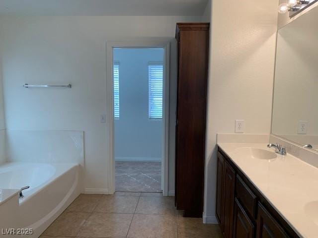 3728 Prairie Orchid Ave, North Las Vegas, NV 89081 - full bathroom featuring double vanity, a bath, tile patterned flooring, and baseboards