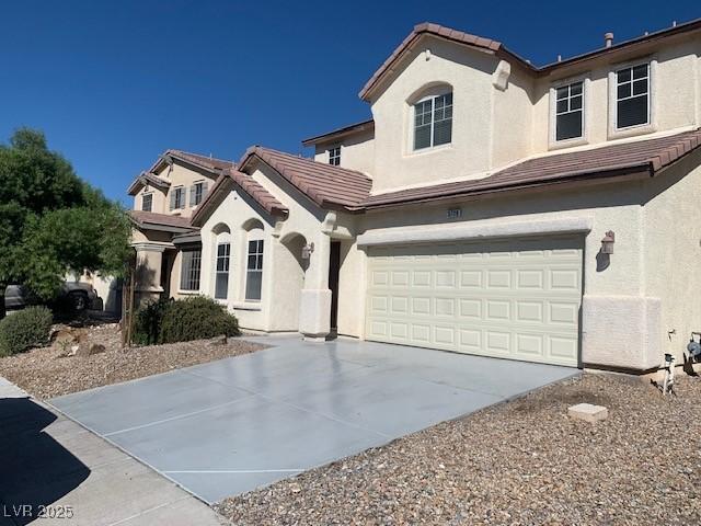 3728 Prairie Orchid Ave, North Las Vegas, NV 89081 - view of front of home with stucco siding, a tiled roof, a garage, and concrete driveway