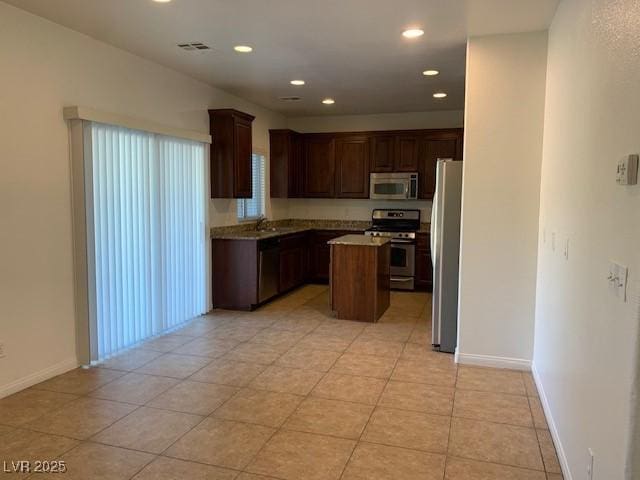3728 Prairie Orchid Ave, North Las Vegas, NV 89081 - kitchen with stainless steel appliances, a center island, recessed lighting, baseboards, and light countertops