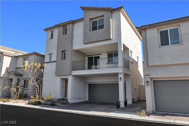 6952 Crescent Gold St, North Las Vegas, NV 89086 - townhome / multi-family property with stucco siding, an attached garage, and a balcony