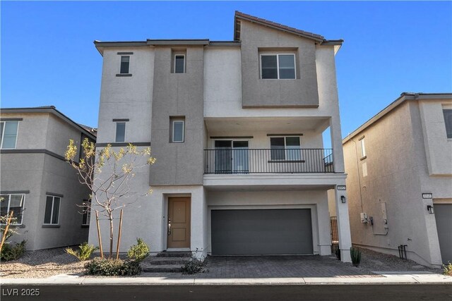 6952 Crescent Gold St, North Las Vegas, NV 89086 - townhome / multi-family property with stucco siding, a garage, a balcony, and decorative driveway
