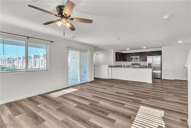 6952 Crescent Gold St, North Las Vegas, NV 89086 - unfurnished living room with a ceiling fan, recessed lighting, wood finished floors, and baseboards