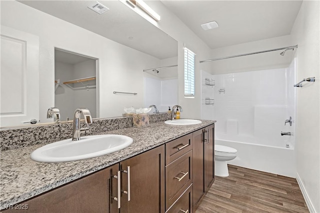 6952 Crescent Gold St, North Las Vegas, NV 89086 - bathroom with wood finished floors, double vanity, toilet, and washtub / shower combination