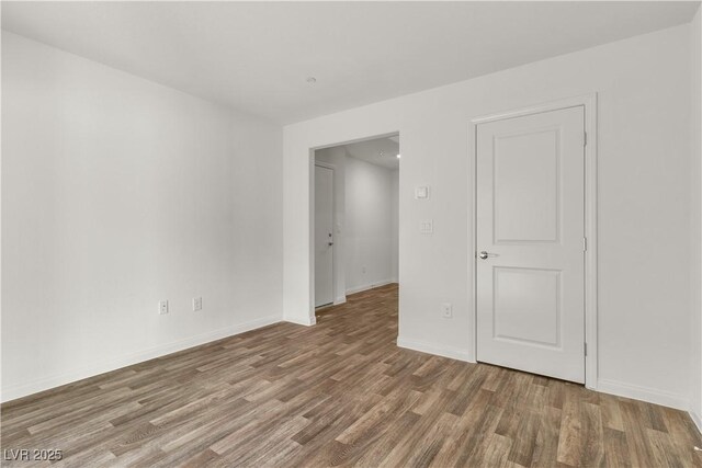 6952 Crescent Gold St, North Las Vegas, NV 89086 - empty room with wood finished floors and baseboards