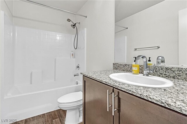 6952 Crescent Gold St, North Las Vegas, NV 89086 - full bathroom with vanity, toilet, wood finished floors, and tub / shower combination