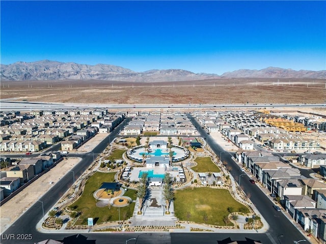 6952 Crescent Gold St, North Las Vegas, NV 89086 - aerial view of property's location with a pool, a mountainous background, and nearby suburban area