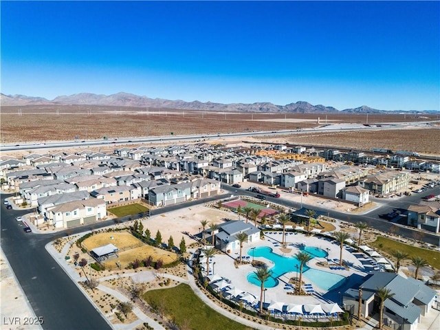 6952 Crescent Gold St, North Las Vegas, NV 89086 - aerial overview of property's location featuring mountains, a pool area, and nearby suburban area