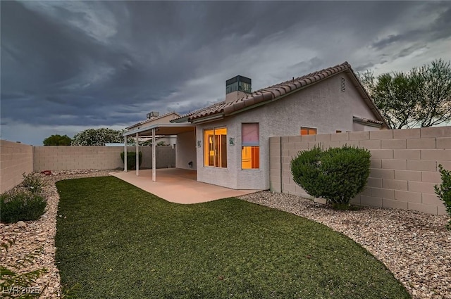 3426 Side Saddle Ct, North Las Vegas, NV 89032 - back of property with a tiled roof, stucco siding, a patio area, and a chimney