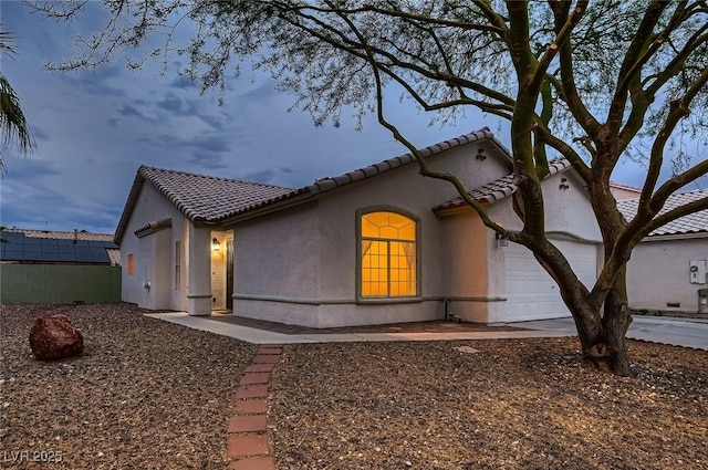3426 Side Saddle Ct, North Las Vegas, NV 89032 - view of property exterior with stucco siding, a tile roof, and a garage