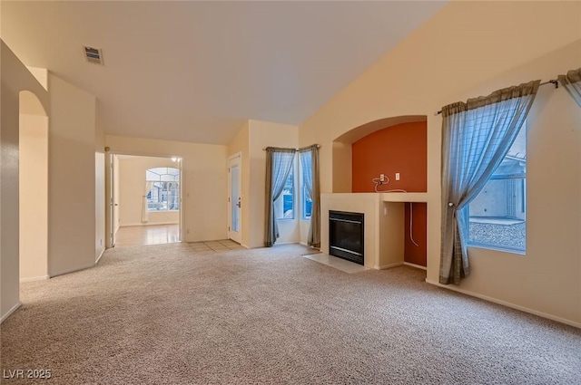 3426 Side Saddle Ct, North Las Vegas, NV 89032 - unfurnished living room with light carpet, a fireplace with flush hearth, baseboards, and vaulted ceiling