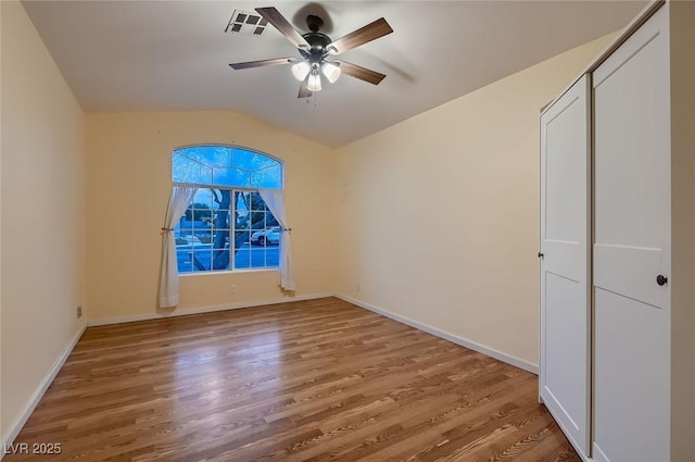 3426 Side Saddle Ct, North Las Vegas, NV 89032 - spare room featuring wood finished floors, a ceiling fan, vaulted ceiling, and baseboards