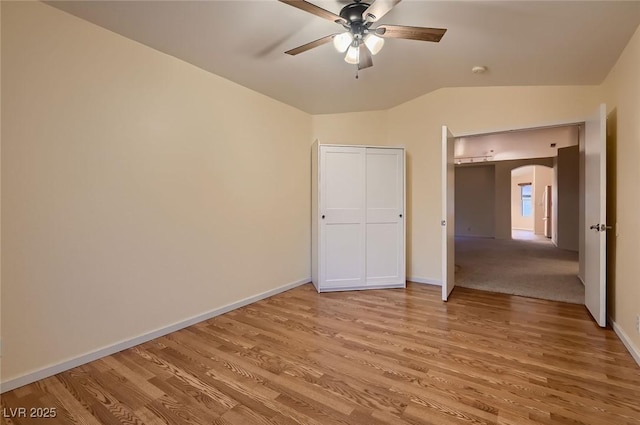 3426 Side Saddle Ct, North Las Vegas, NV 89032 - unfurnished bedroom with light wood finished floors, baseboards, lofted ceiling, arched walkways, and ceiling fan