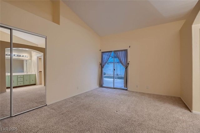 3426 Side Saddle Ct, North Las Vegas, NV 89032 - unfurnished room with carpet floors, arched walkways, high vaulted ceiling, and baseboards