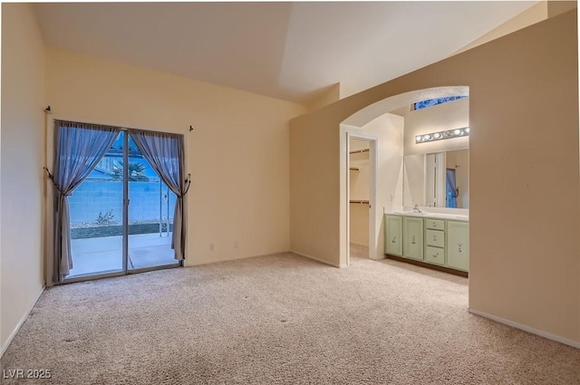 3426 Side Saddle Ct, North Las Vegas, NV 89032 - unfurnished bedroom featuring arched walkways, light carpet, access to outside, and a sink