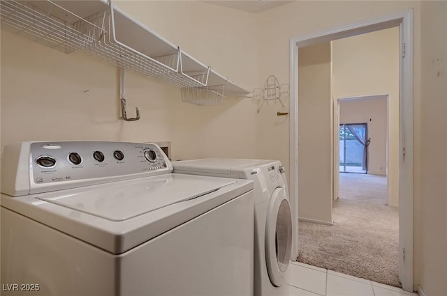 3426 Side Saddle Ct, North Las Vegas, NV 89032 - laundry area with washing machine and clothes dryer, light carpet, and light tile patterned floors
