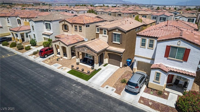 7694 Hampton Park Ln, Las Vegas, NV 89113 - view of front of property featuring a residential view, driveway, stucco siding, an attached garage, and a tile roof
