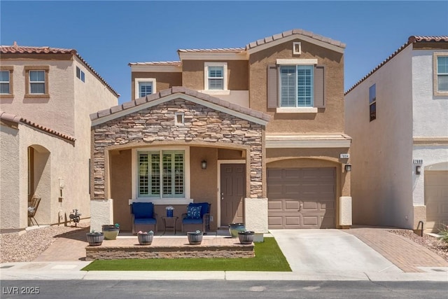 7694 Hampton Park Ln, Las Vegas, NV 89113 - view of front of house featuring stone siding, an attached garage, driveway, and stucco siding