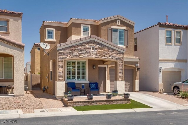 7694 Hampton Park Ln, Las Vegas, NV 89113 - view of front facade featuring driveway, stone siding, stucco siding, a garage, and a tile roof