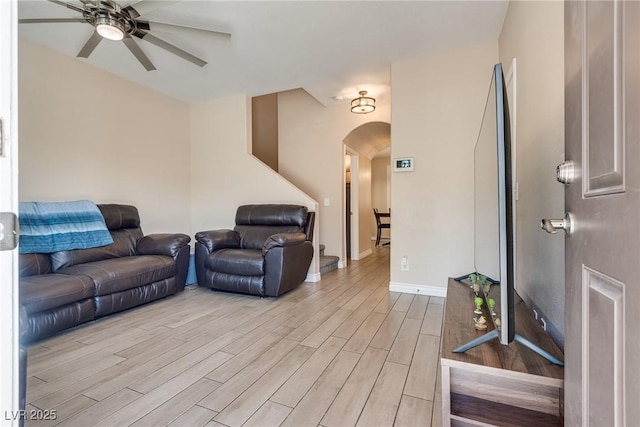 7694 Hampton Park Ln, Las Vegas, NV 89113 - living area with arched walkways, ceiling fan, light wood-type flooring, and baseboards