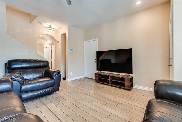 7694 Hampton Park Ln, Las Vegas, NV 89113 - living room with arched walkways, light wood-style floors, baseboards, and recessed lighting