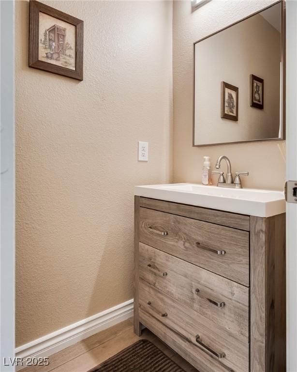 7694 Hampton Park Ln, Las Vegas, NV 89113 - bathroom featuring vanity and a textured wall