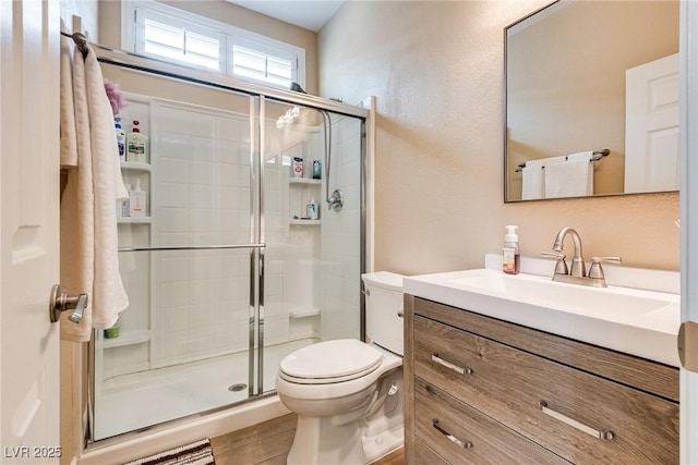 7694 Hampton Park Ln, Las Vegas, NV 89113 - full bathroom with vanity, a shower stall, and toilet