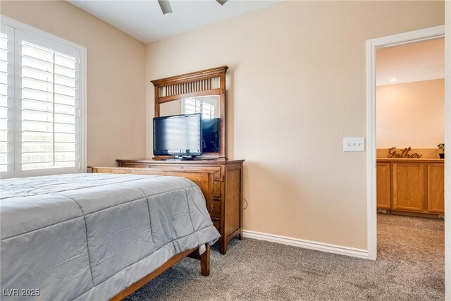 7694 Hampton Park Ln, Las Vegas, NV 89113 - bedroom featuring light carpet, baseboards, a sink, and ceiling fan