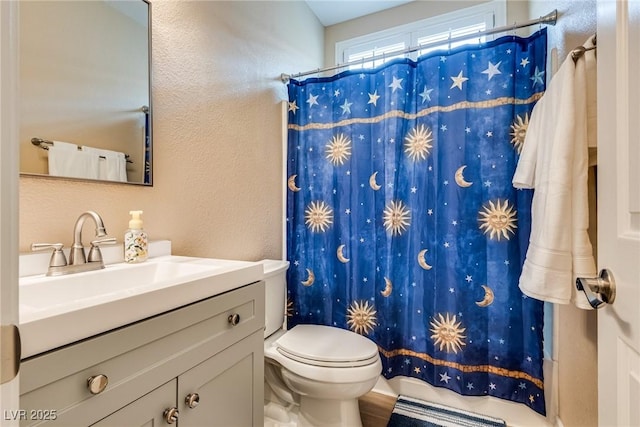 7694 Hampton Park Ln, Las Vegas, NV 89113 - bathroom with vanity, toilet, a textured wall, and shower / bathtub combination with curtain