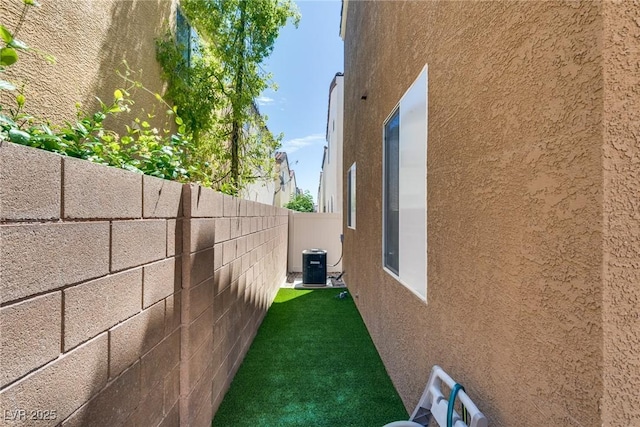 7694 Hampton Park Ln, Las Vegas, NV 89113 - view of side of property with stucco siding and central air condition unit