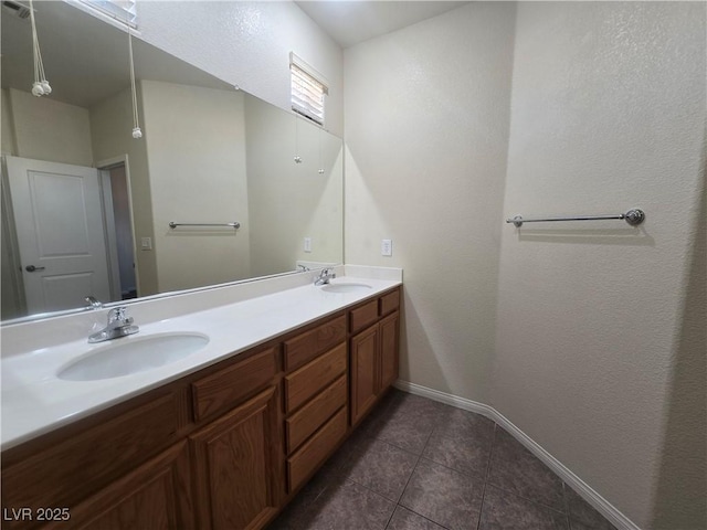 9312 Gold Dove Ct, Las Vegas, NV 89178 - bathroom featuring baseboards, tile patterned floors, and double vanity
