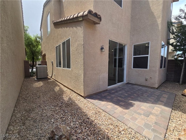 9312 Gold Dove Ct, Las Vegas, NV 89178 - back of property with stucco siding, central AC, and a patio