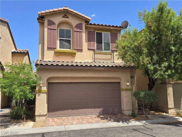 9312 Gold Dove Ct, Las Vegas, NV 89178 - mediterranean / spanish-style home with an attached garage, stucco siding, a tile roof, and decorative driveway