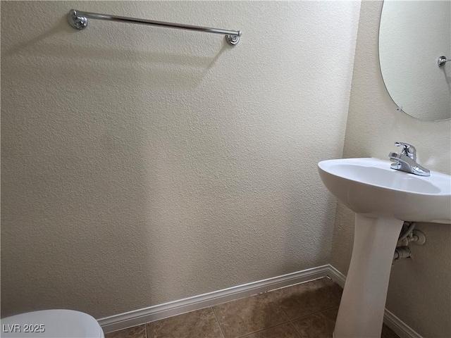 9312 Gold Dove Ct, Las Vegas, NV 89178 - bathroom featuring baseboards, tile patterned floors, and toilet