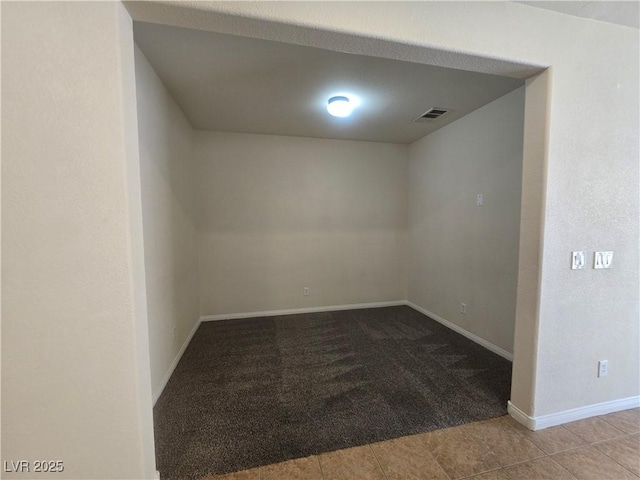 9312 Gold Dove Ct, Las Vegas, NV 89178 - spare room with carpet flooring, baseboards, and tile patterned flooring