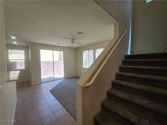 9312 Gold Dove Ct, Las Vegas, NV 89178 - stairs with baseboards, tile patterned floors, ceiling fan, and a textured ceiling