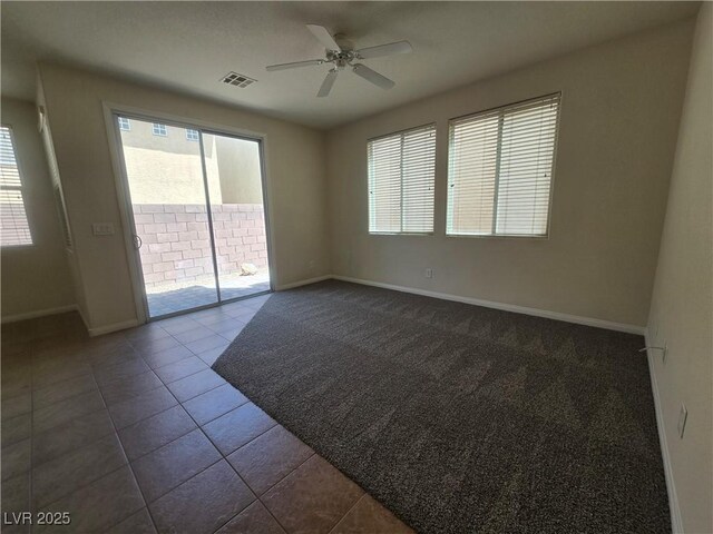 9312 Gold Dove Ct, Las Vegas, NV 89178 - empty room featuring baseboards, ceiling fan, healthy amount of natural light, and dark tile patterned flooring