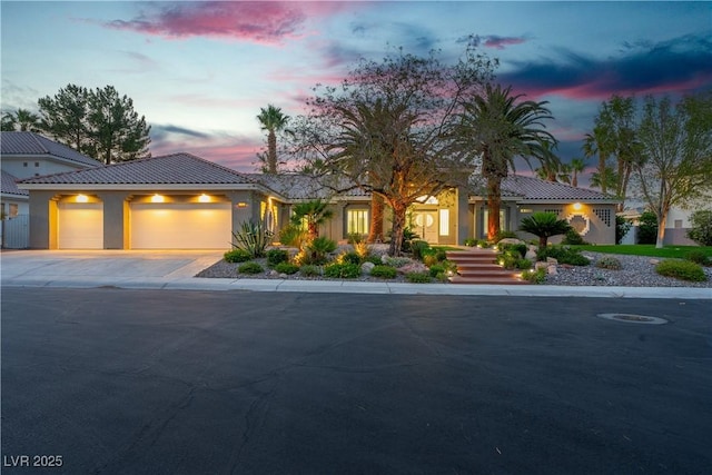 7738 Willow Cove Cir, Las Vegas, NV 89129 - view of front of property with a tile roof, driveway, an attached garage, and stucco siding