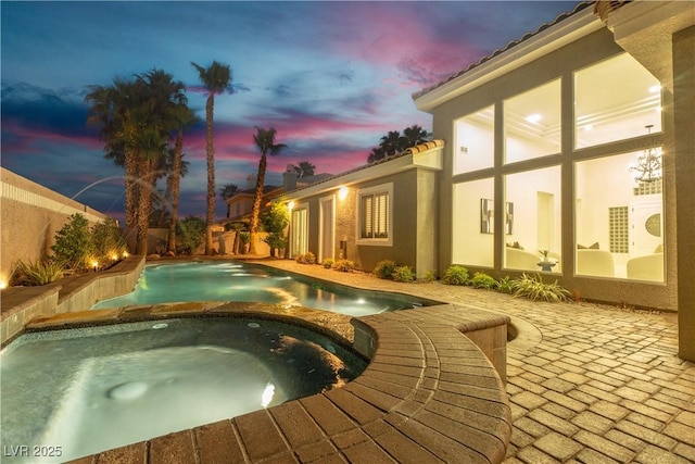 7738 Willow Cove Cir, Las Vegas, NV 89129 - pool at dusk with a patio and a pool with connected hot tub