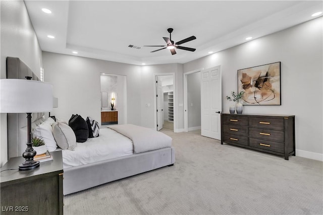 7738 Willow Cove Cir, Las Vegas, NV 89129 - bedroom with recessed lighting, baseboards, light colored carpet, a tray ceiling, and ensuite bath