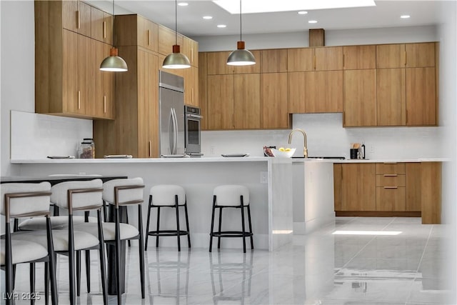 7738 Willow Cove Cir, Las Vegas, NV 89129 - kitchen with modern cabinets, appliances with stainless steel finishes, decorative backsplash, a kitchen breakfast bar, and decorative light fixtures